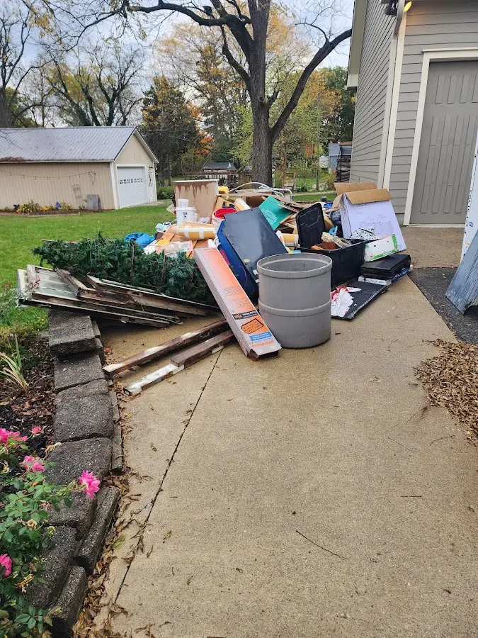 Dumpster being loaded with debris for Roofing Dumpster Rental in Waukegan